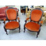 A pair of 19thC profusely foliate and C-scroll carved mahogany showwood framed salon chairs with