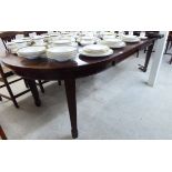 A 1920s mahogany oval wind-out dining table 30''h 54''L extending to 94''L with two additional