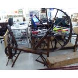 The principal component parts of a 19thC country made fruitwood, oak and elm spinning wheel,