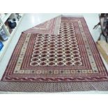 A Turkish rug with elephant foot motifs on a cream and maroon ground 110'' x 110'' CA