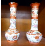 A pair of early 20thC Japanese porcelain vases, traditionally decorated in iron red with flora 9.