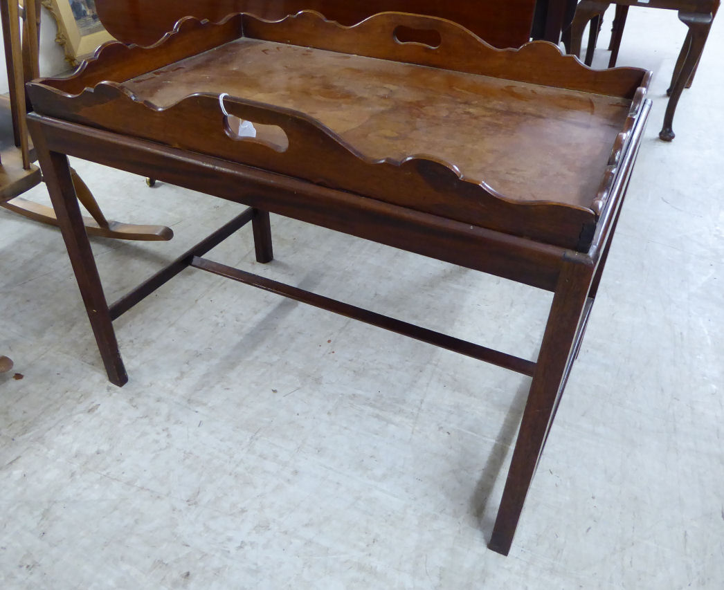 An early 20thC George III butler's design mahogany tray top occasional table, raised on square,