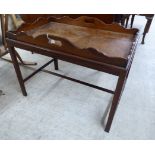 An early 20thC George III butler's design mahogany tray top occasional table, raised on square,