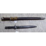 An early 20thC bayonet the blade 17''h in a sheath; and another similar 10.