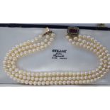 A triple row cultured pearl choker, on a 9ct gold clasp,
