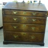 A George III oak bureau with a fall flap, over four graduated long drawers,