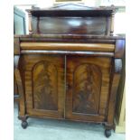 A mid Victorian mahogany chiffonier with a galleried upstand, over two panelled doors,