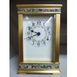 A modern lacquered brass and champleve enamel cased carriage timepiece with bevelled glass panels