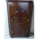 An early 20thC string inlaid mahogany corner cabinet with a pair of panelled doors,