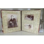 A late Victorian red velvet clad photograph album containing various portraits OS10