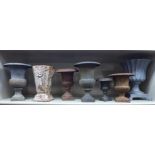 Seven 20thC cast iron urns of varying designs 5''-9.