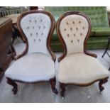 Two similar late Victorian mahogany showwood framed nursing chairs with part-button upholstered