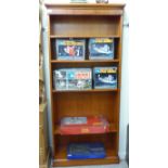 A modern yew wood open front bookcase with five shelves,
