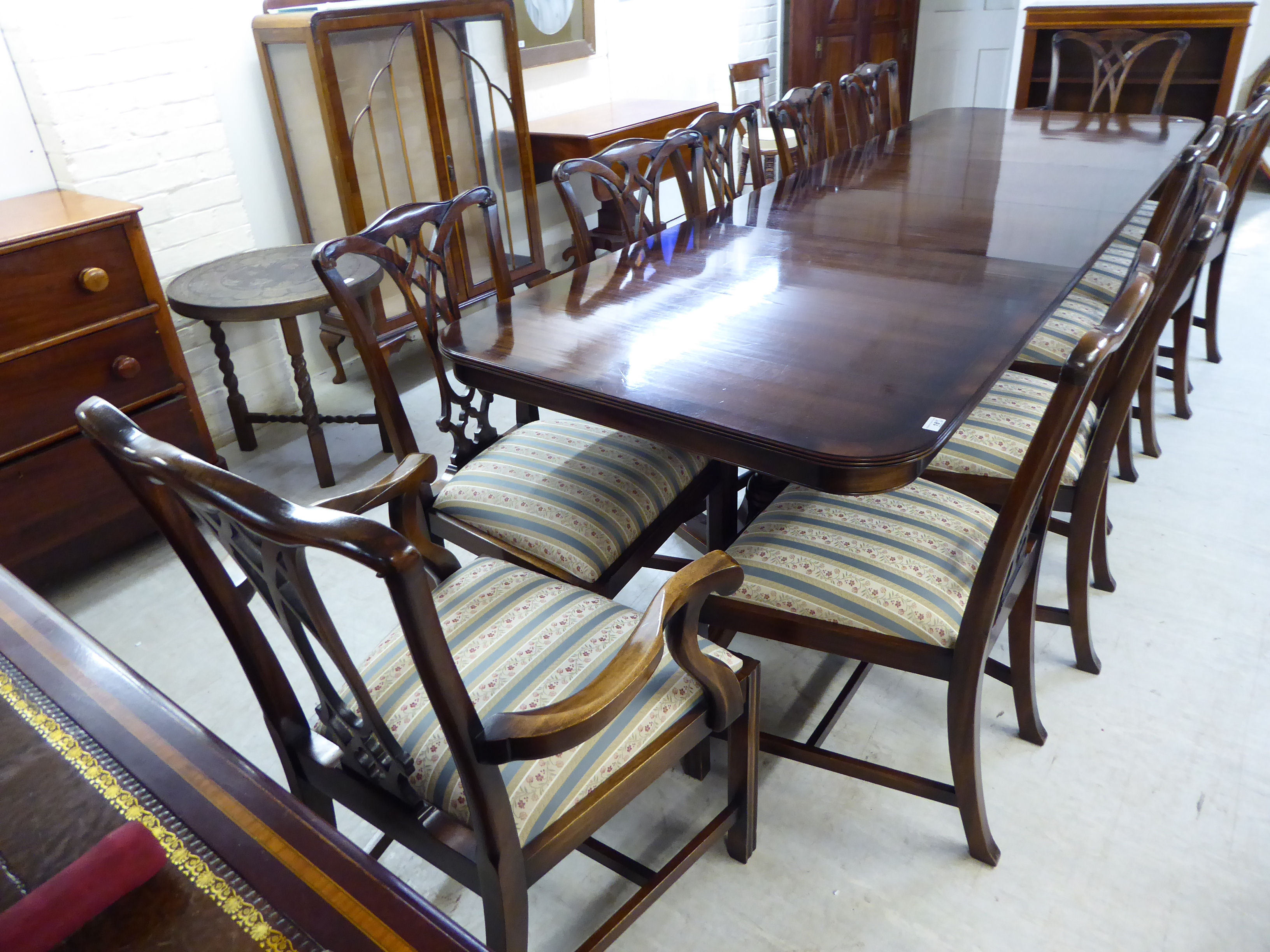 A Rackstraw Regency style string inlaid crossbanded mahogany twin pedestal dining table,