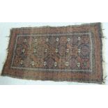 A Persian rug with a central gul medallion on a blue ground 56'' x 32'' SL