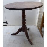 A mid 19thC mahogany tip-top pedestal table, over a ring turned column,