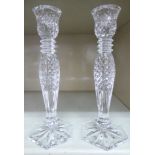 A pair of Waterford crystal candlesticks with vase shaped sockets,