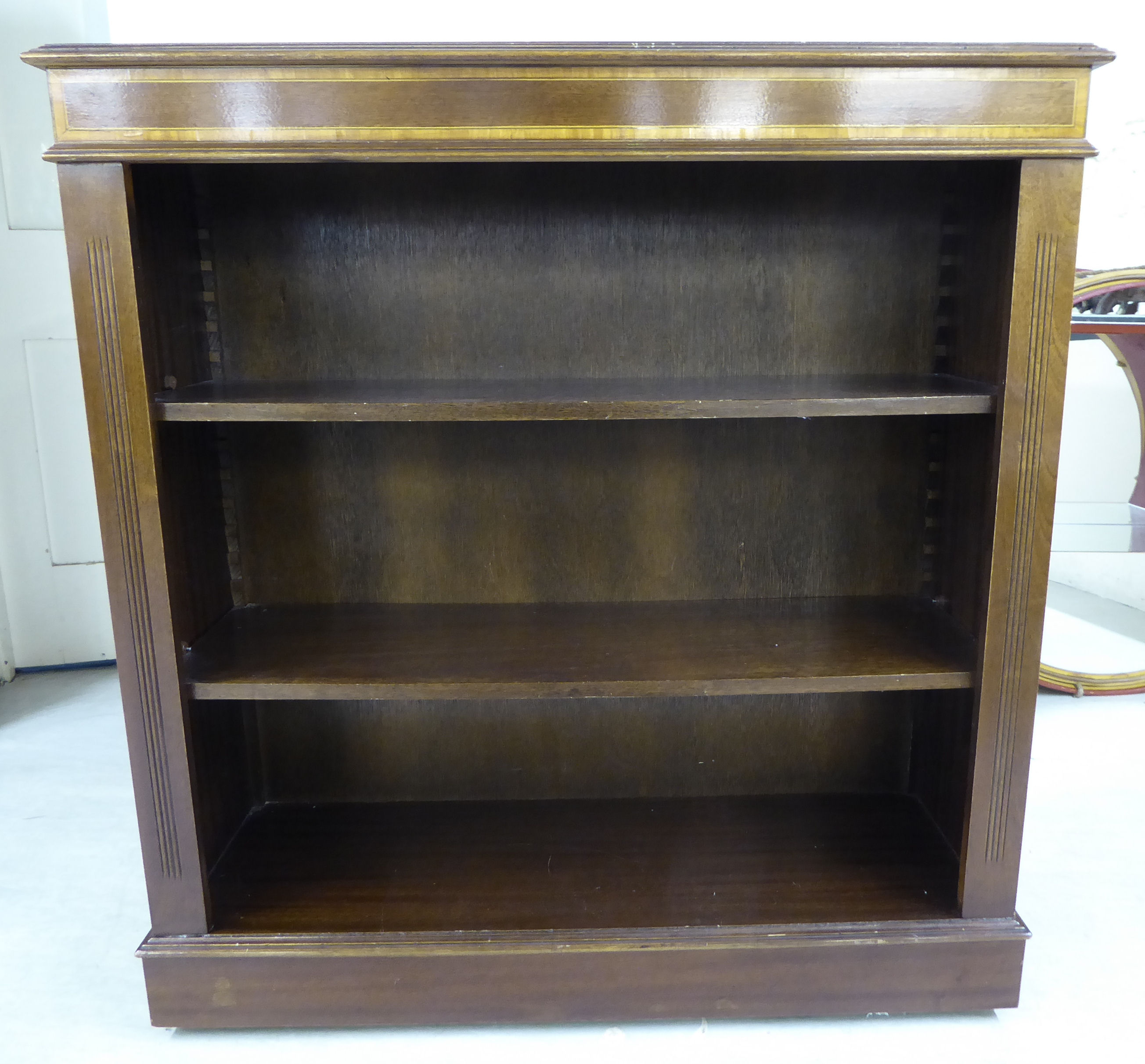 A modern Edwardian style mahogany open front bookcase with two shelves,