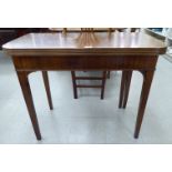 A Regency mahogany tea table with a foldover top, raised on square,