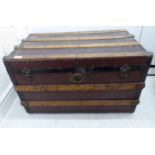 An early 20thC beech bound canvas trunk with straight sides and a hinged lid,
