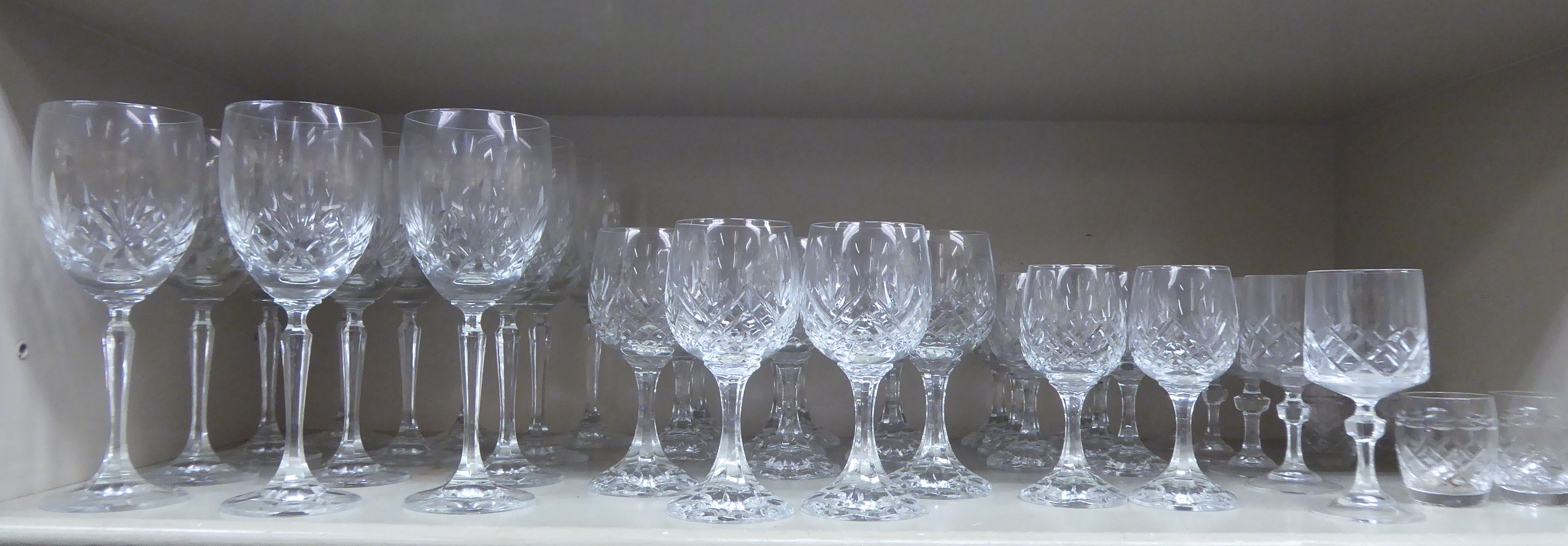 Slice decorated crystal stemmed drinking glasses comprising hocks,