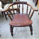An early 20thC beech framed captains' design desk chair with a spindled back,