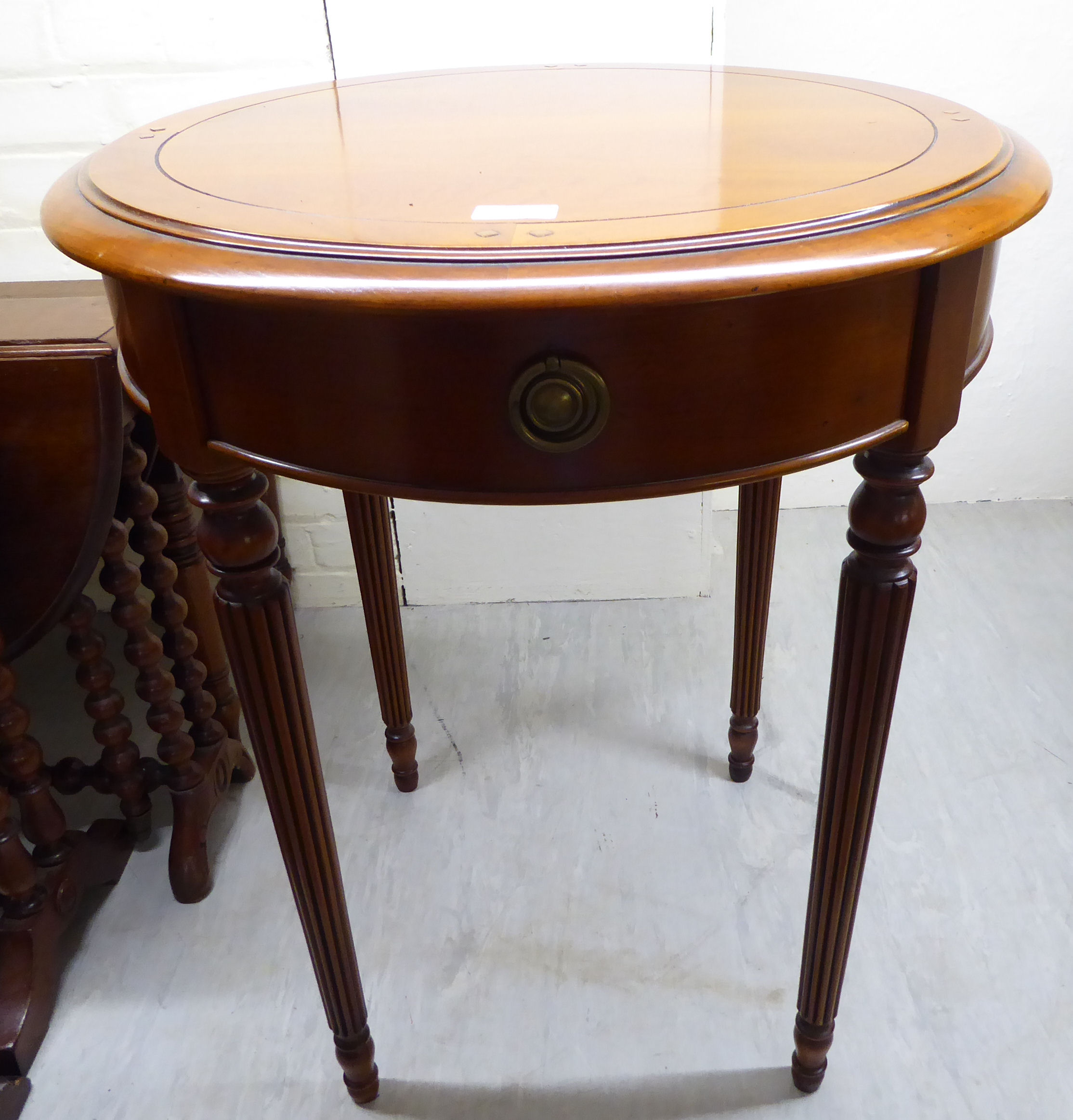 A modern 'Delightful Designs Romantique' walnut lamp table, raised on tapered,