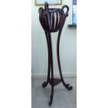 A modern Victorian style mahogany jardiniere with a pierced bowl design top,