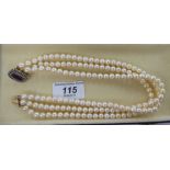 A triple row cultured pearl choker, on a 9ct gold clasp,