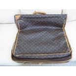 A Louis Vuitton suit carrier/holdall with brown hide handles,