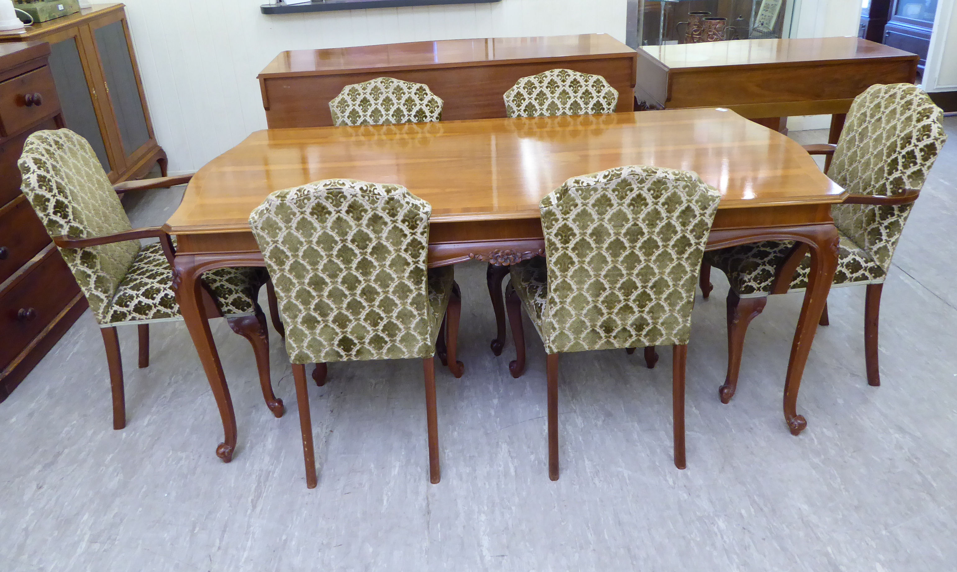 A mid 20thC walnut veneered dining suite, viz.