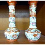 A pair of early 20thC Japanese porcelain vases, traditionally decorated in iron red with flora 9.