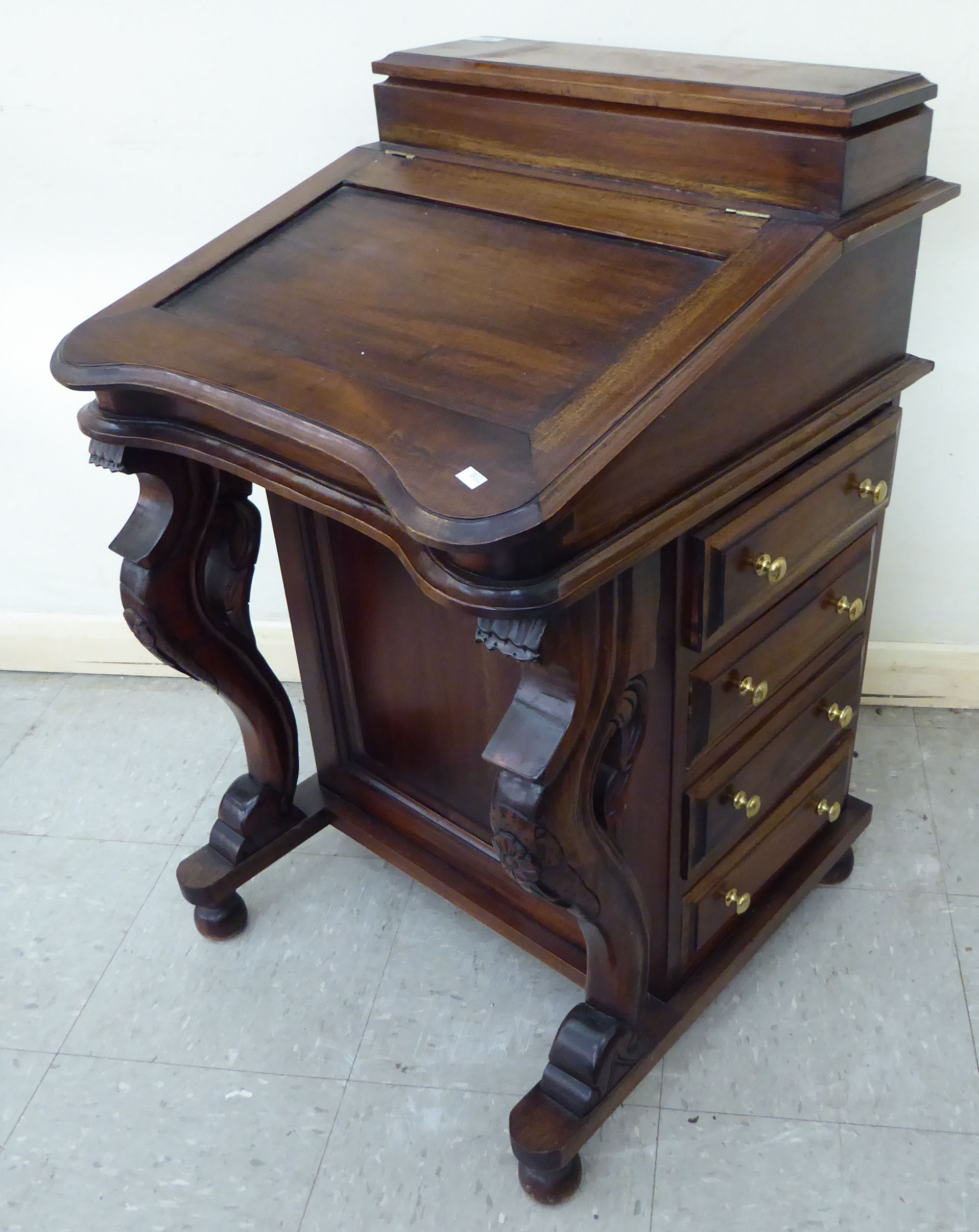 A modern mahogany finished Canterbury with a hinged top, four side drawers and opposing facsimiles,