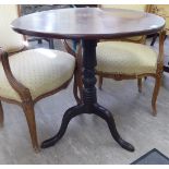 A George III mahogany tip-top pedestal table, over a ring turned column,