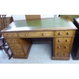 An early 20thC lady's mahogany twin pedestal, nine drawer desk,