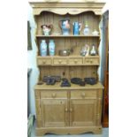 A modern pine dresser, the superstructure with two plate racks and four drawers,