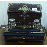 A late Victorian brass mounted walnut deskstand with a lidded stationary compartment and two glass