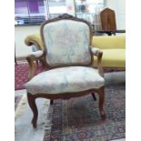 A modern French inspired mahogany showwood framed, fabric upholstered open arm salon chair,