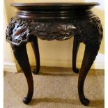 A 1930s/mid 20thC Chinese fruitwood centre table, the crossover top with a floral carved frieze,