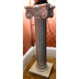 A modern china torchere, fashioned as a Corinthian capital,