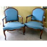 A pair of late 19thC French stained beech framed open arm chairs with blue fabric upholstered backs