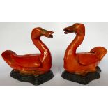 A pair of early 20thC Chinese red glazed porcelain model ducks with gilded features 64''h