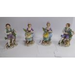 Two similar pairs of early 20thC Sitzendorf porcelain figures, a seated woman and man,