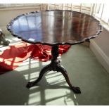 A mid 19thC style mahogany pedestal table, the top with a piecrust edge, raised on a fluted column,