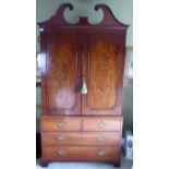 A George III mahogany linen press with a swan neck pediment,