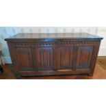 A late 18thC oak coffer, having a planked lid, the front with a carved, fluted frieze,