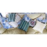 An eclectic collection of tapestry fabric and other variously patterned scatter cushions