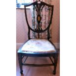 An Edwardian string inlaid mahogany framed splat back nursing chair, raised on square,