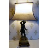 An early 20thC painted spelter and gilt metal mounted table lamp,