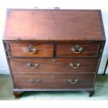 A George III mahogany bureau, the fall front, enclosing a fitted interior,